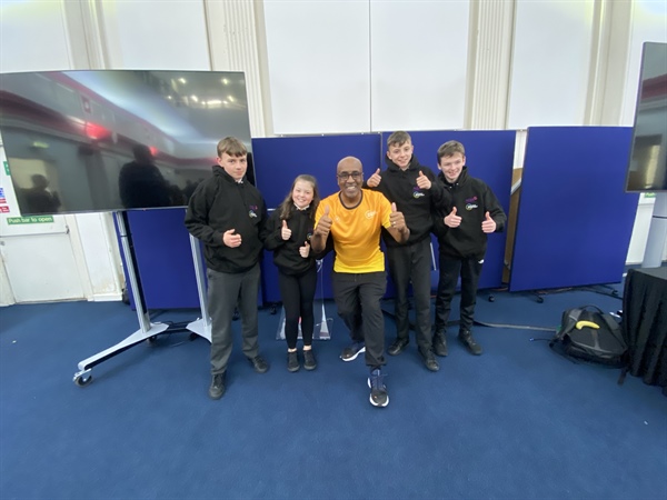 Four students teach their peers about helping children in need